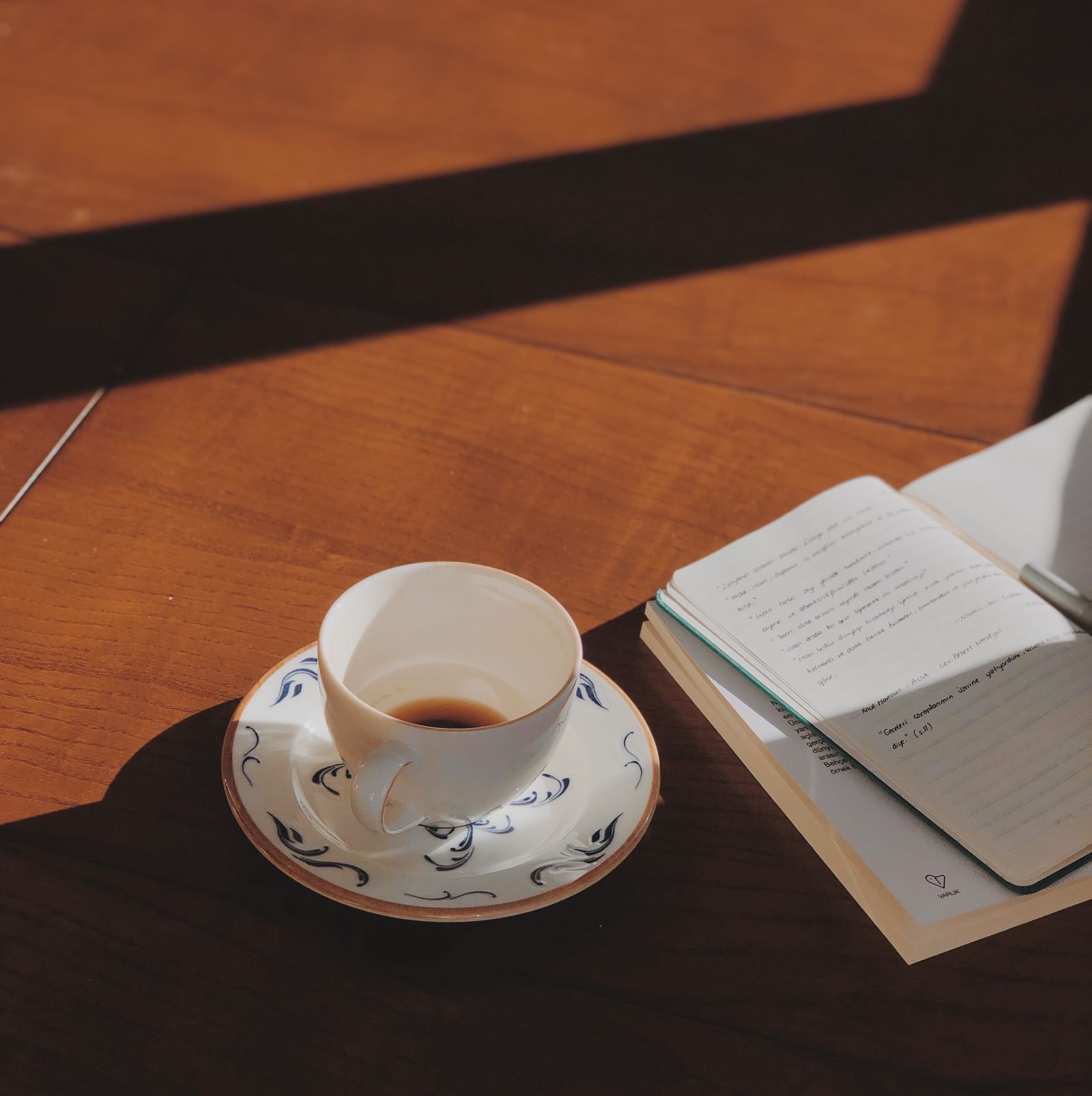 A cup of coffee on a wooden surface