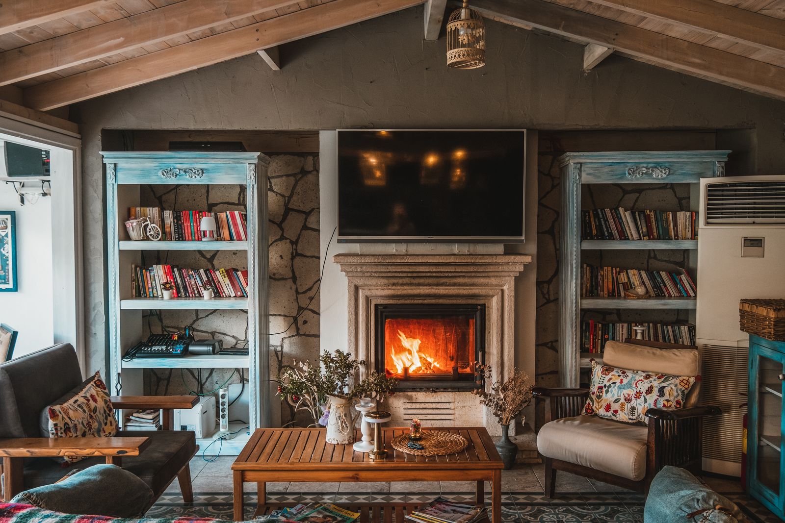 A cozy living room with an area rug in front of a fireplace