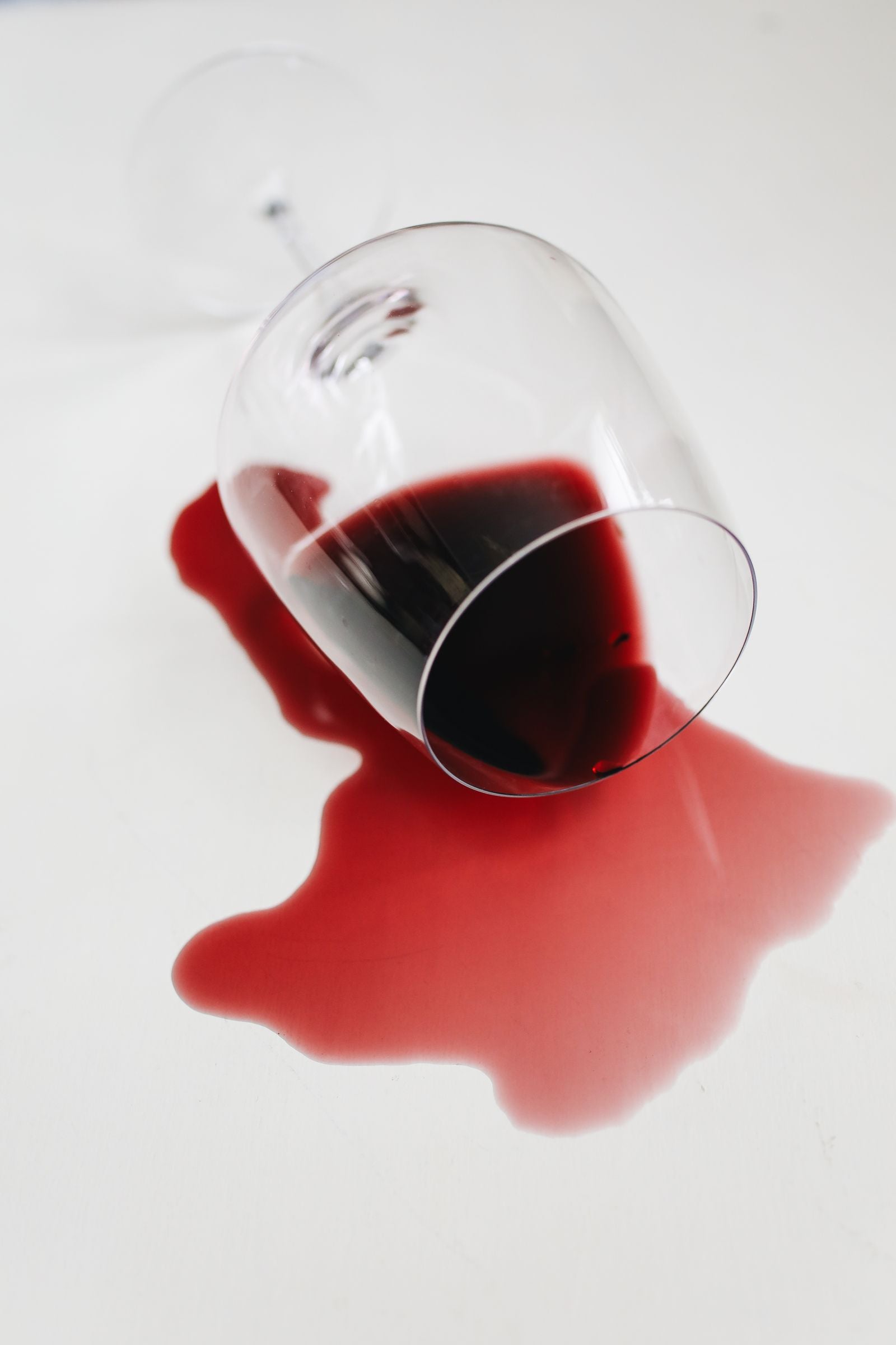 A spilled glass of red wine