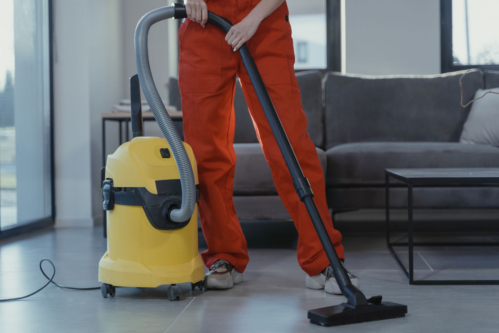 Person using a rented carpet cleaner machine at home