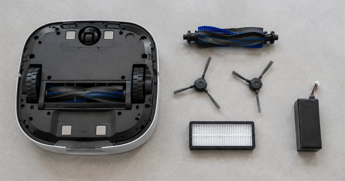 Robot vacuum turned upside down beside its replaceable parts: brush roll, two side brushes, pleated filter and battery pack